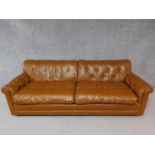 A vintage brown leather button backed sofa. H.72 W.220 D.90cm
