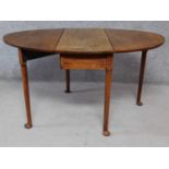 A Georgian mahogany drop flap dining table on cabriole supports. H.70 L.131 W.90cm