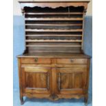 A 19th century French provincial chestnut dresser with open plate rack above two frieze drawers