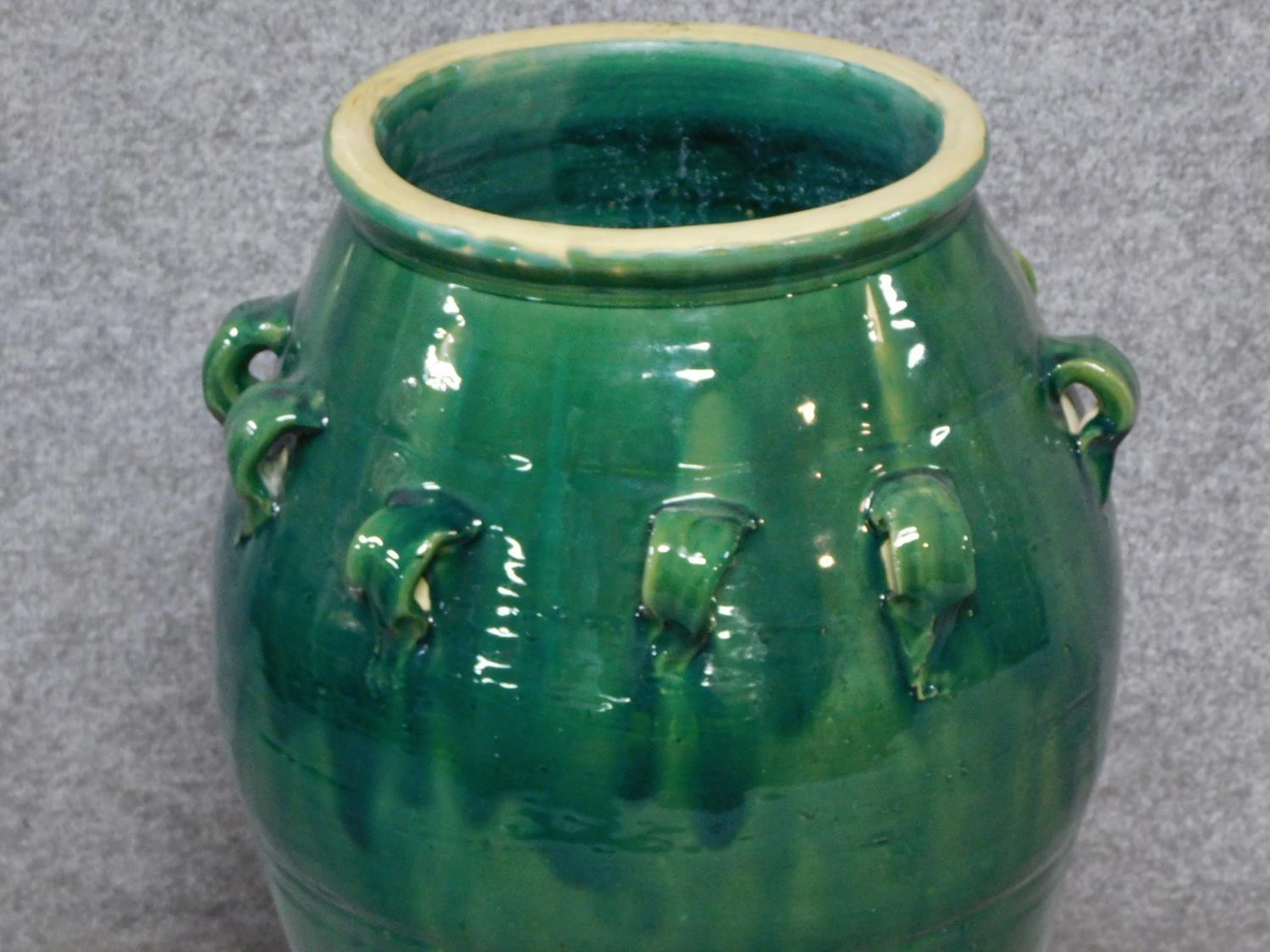 A large green drip glazed sharab wine vessel with handles. H.74cm - Image 2 of 3