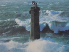A large framed print depicting a lighthouse in a stormy sea. 134x58cm