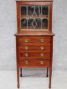 An Edwardian mahogany vitrine with Art Nouveau style leaded panel doors above 4 drawers on square