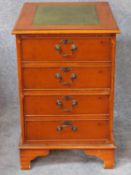 A Georgian style yew filing cabinet with inset leather top above two deep drawers on bracket feet.