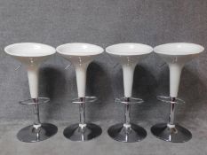 A set of four contemporary moulded adjustable high stools on chrome platform bases. H.87cm