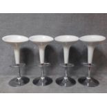 A set of four contemporary moulded adjustable high stools on chrome platform bases. H.87cm