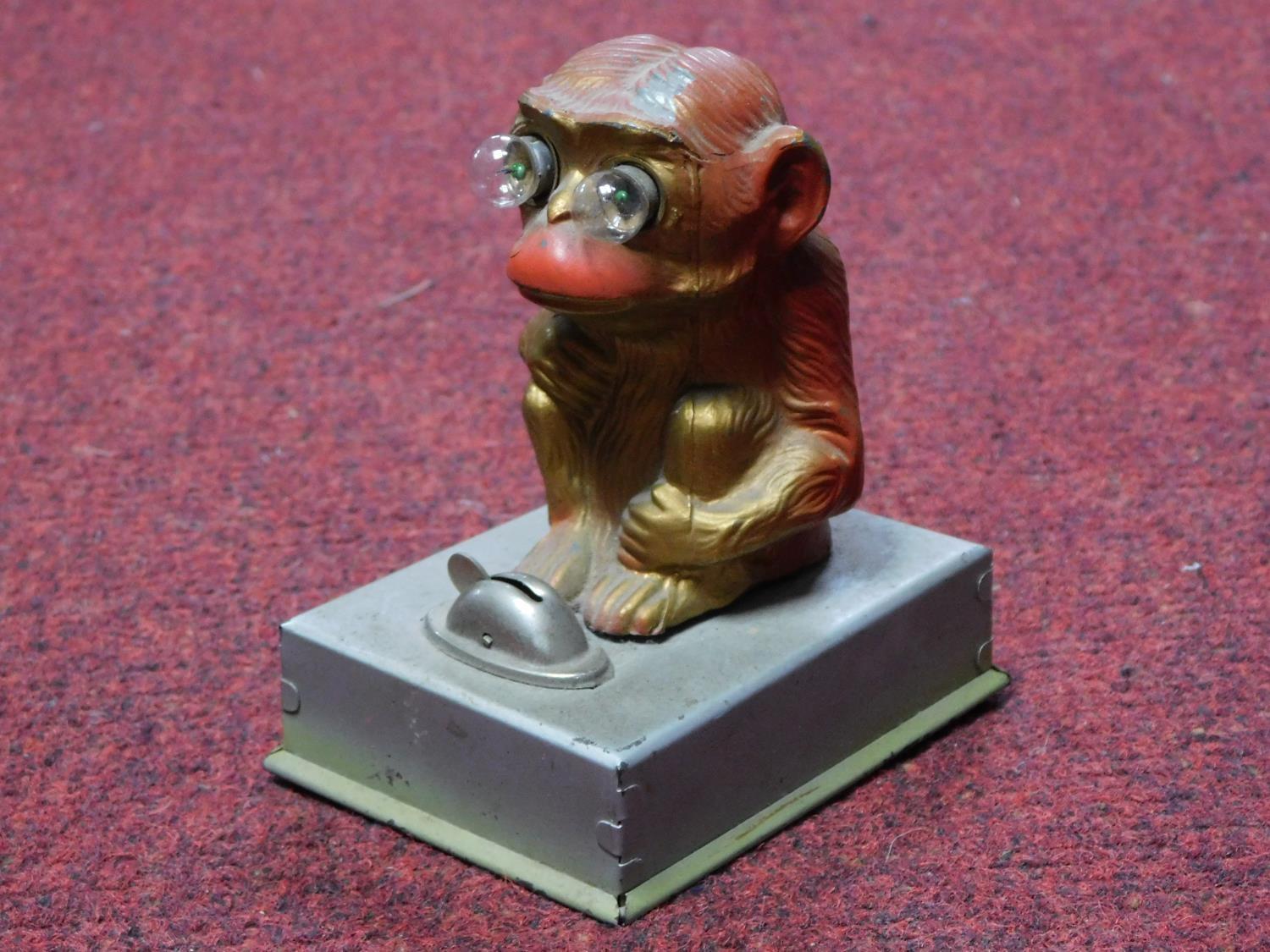 A vintage painted tin plate monkey light, it's eyes light up and is battery powered. H.12cm - Image 2 of 3