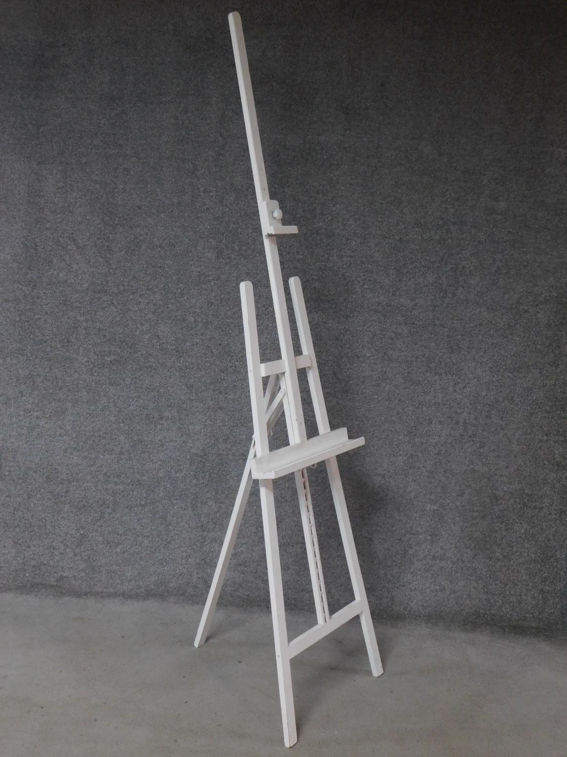 A Windsor & Newton white painted adjustable easel. 222x56cm