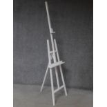 A Windsor & Newton white painted adjustable easel. 222x56cm