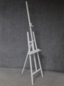 A Windsor & Newton white painted adjustable easel. 222x56cm