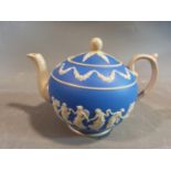 A 19th century Copeland blue and white jasperware dancing hours tea pot. It features a raised