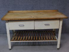 A vintage pine topped and metal framed kitchen side table fitted with two frieze drawers on square