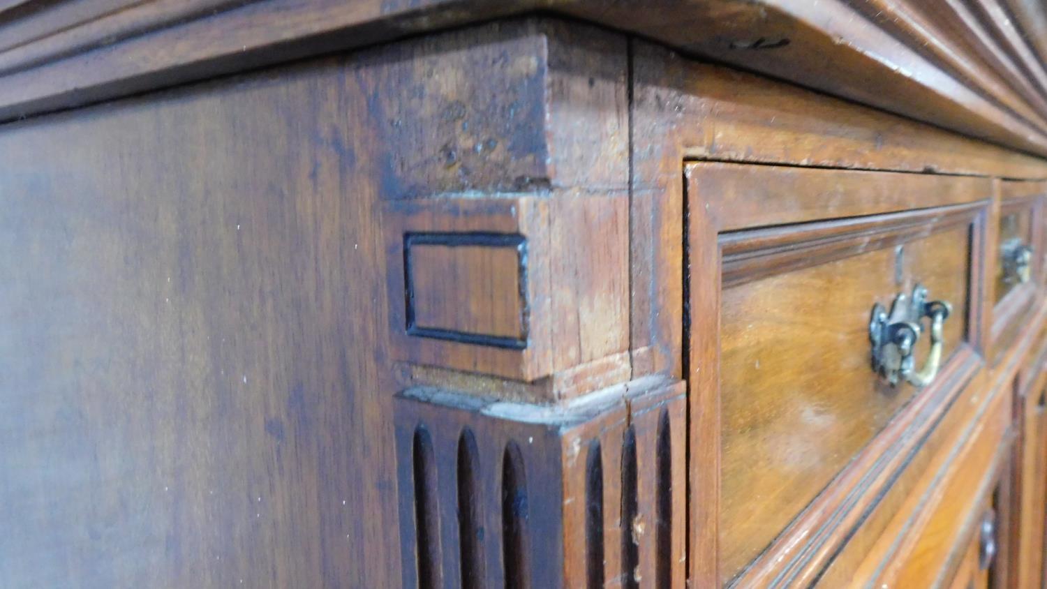A 19th century mahogany press cupboard with three frieze drawers over panel doors enclosing linen - Image 5 of 6