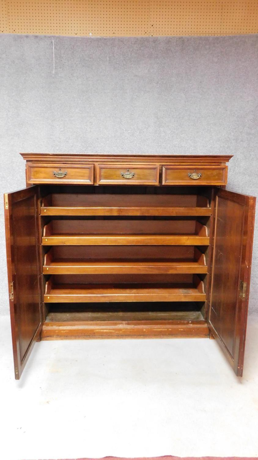 A 19th century mahogany press cupboard with three frieze drawers over panel doors enclosing linen - Image 2 of 6