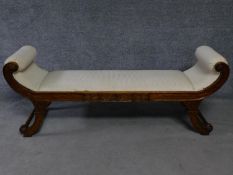 A Regency style mahogany window seat on swept supports. H.65 W.165 D.48cm