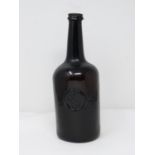 An 18th century All Souls College common room, Oxford sealed brown glass wine bottle. H25.5cm.