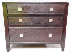 A contemporary ebonised three drawer chest. H.69 W.81 D.56cm