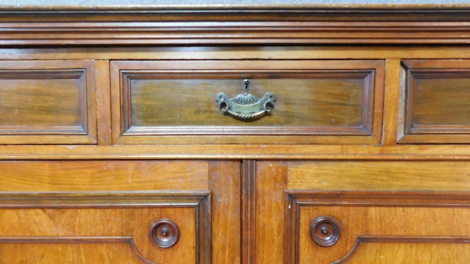 A 19th century mahogany press cupboard with three frieze drawers over panel doors enclosing linen - Image 3 of 6