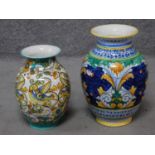 Two Italian hand painted majolica vases with colourful floral and foliate designs, one with birds.