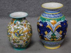 Two Italian hand painted majolica vases with colourful floral and foliate designs, one with birds.