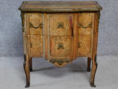 A 19th century Continental walnut two drawer commode with ormolu edges and mounts and allover