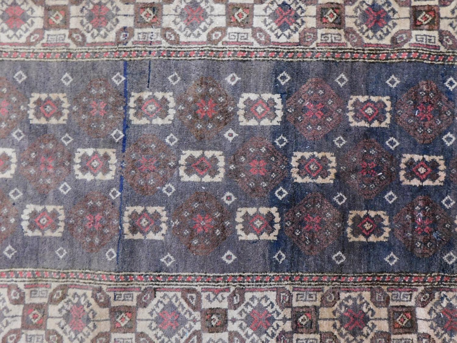 An antique Baluch rug, Persia, c.1900, c. 140 x 90 cm A modern Turkish rug, 20th century, 178x76cm - Image 5 of 7