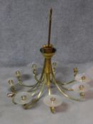 A large nine branch brass chandelier with frosted glass shades. H.110 W.110cm (two shades missing).