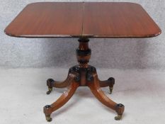 A Regency mahogany fold over top tea table on quadruped reeded supports terminating in brass
