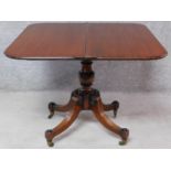 A Regency mahogany fold over top tea table on quadruped reeded supports terminating in brass