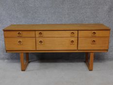 A vintage Schreiber teak chest of drawers on platform base. H.68 W.152 D.43cm