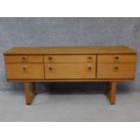 A vintage Schreiber teak chest of drawers on platform base. H.68 W.152 D.43cm