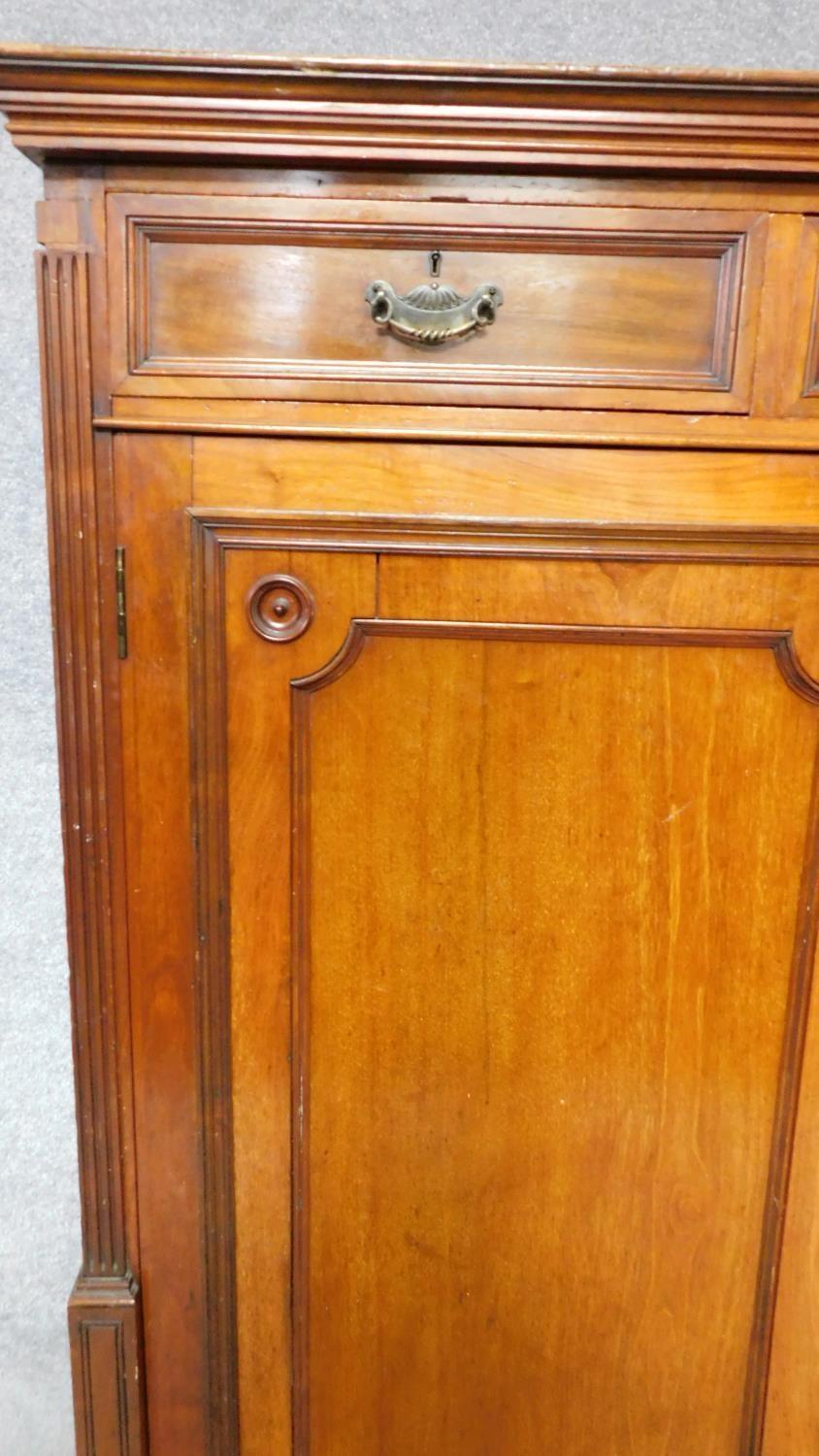 A 19th century mahogany press cupboard with three frieze drawers over panel doors enclosing linen - Image 4 of 6