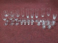 A collection of vintage glasses including a set of six brandy glasses, four engraved shot glasses, a