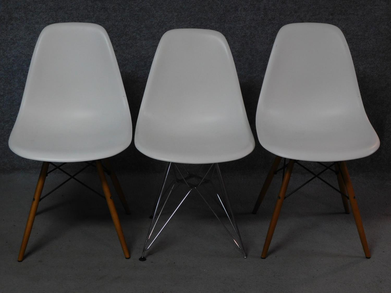 A pair of Eames Vitra dining chairs and a similar chair. H.82cm