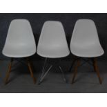 A pair of Eames Vitra dining chairs and a similar chair. H.82cm