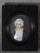 A 19th century ebonised framed painted miniature on ivory of a blonde lady with curly hair in a