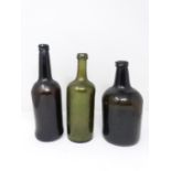 Three 18th century glass wine bottles. Two brown mallet shaped bottles and one green cylindrical