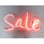 A neon tube wall mounted light up sign. (light doesnt stay on). 60x111cm