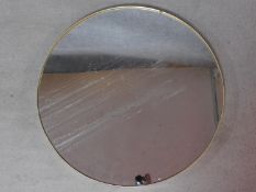 A large circular gilt framed wall mirror. 90x90cm