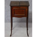 An Edwardian mahogany sewing box with fitted interior on swept supports. H.70 W.39 D.35cm