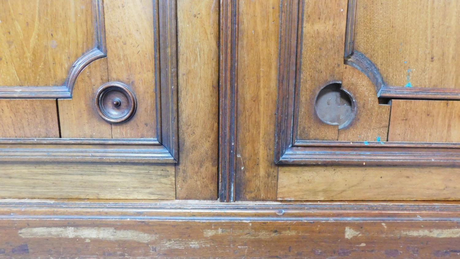 A 19th century mahogany press cupboard with three frieze drawers over panel doors enclosing linen - Image 6 of 6