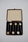 A set of cased Art Deco silver plate coffee spoons with shell bowls and bakelite coffee bean