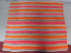 A contemporary linear rug with repeating orange and pink stripes on a grey field 180x200cm