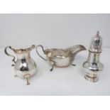 A collection of silver including a three footed antique cream jug, hallmarked worn, a three footed