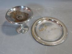 A silver plate pedestal bowl stamped D & P for Davies and Powers and a round tray with repousse