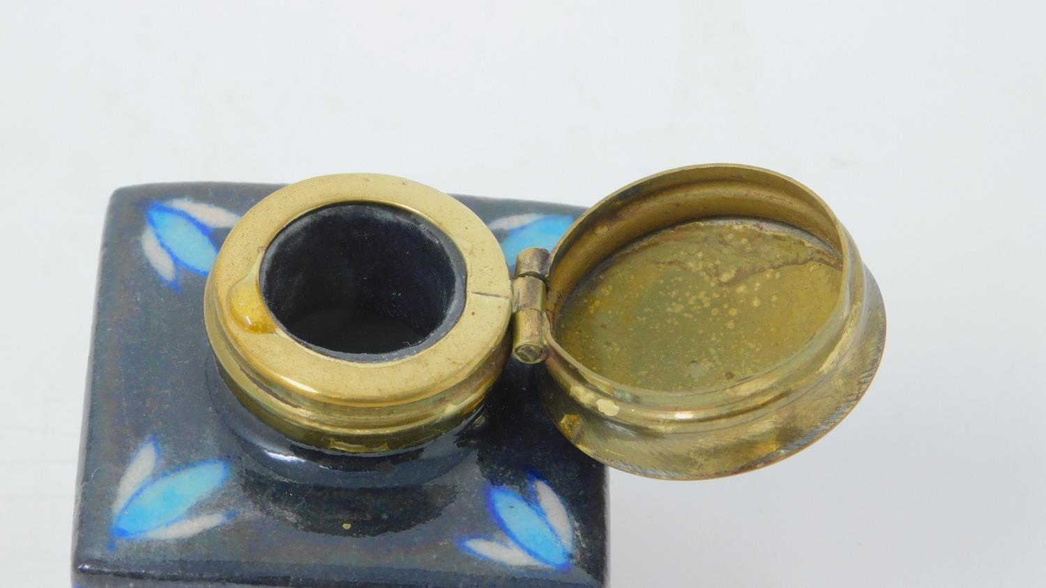 An antique glazed ceramic perfume bottle with brass lid, decorated with a stylized floral and - Image 4 of 5