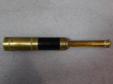 An antique brass telescope. W.32cm