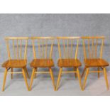 A set of four vintage Ercol style elm seated dining chairs with beech stick backs, rails and legs.