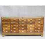 A vintage oak and brass twenty five drawer haberdashery shop display counter with ivory bakelite