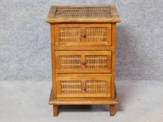 An Eastern teak and bamboo small chest of drawers. H.66 W.44 D.41cm