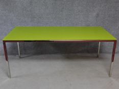 A contemporary glass topped dining table on chrome frame and supports. H.72 W.180 D.80cm